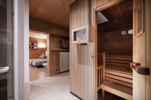 a small room with a sauna and a bedroom at Hotel Alpenstolz in Mieders