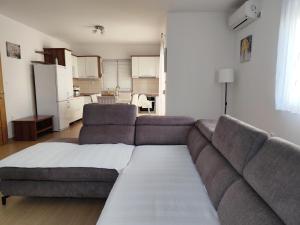a living room with a couch and a kitchen at Apartments Marta in Seline