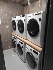 three washing machines are stacked on top of each other at Pepleri 34 mini studio apartment in Tartu