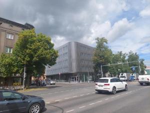 a building on a city street with cars on the road at Pepleri 34 mini studio apartment in Tartu