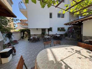 a patio with a table and chairs and a building at Sarievi Holiday Home in Tsarevo
