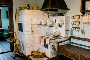 a kitchen with a brick wall with pots and pans at Starodawna Chata - Dziad in Zamość