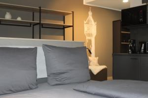 a bed with gray pillows and a chair in a room at Exklusives Wohnen im historischen Wasserturm dem Highlight von Delitzsch WE318 in Delitzsch