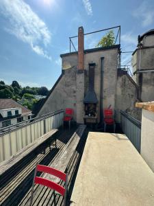 un banco sentado en un balcón con chimenea en Rustic lakeside gem with rooftop looking to Zurich see, en Zúrich