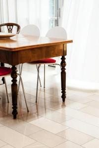a wooden table and chairs on a tile floor at Studio in Schernfeld