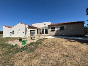 a house with two chairs sitting on a patio at Villa Perle Atlantique in La Vallée