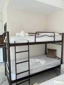 a couple of bunk beds in a room at Alex Studios Paralia Vrasna in Asprovalta