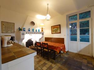 a kitchen with a table and a fireplace in it at Château Rouge - petit château avec piscine - 8 chambres in Bollène