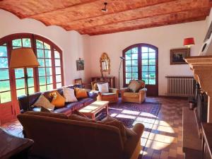 a living room with couches and a fireplace at Château Rouge - petit château avec piscine - 8 chambres in Bollène