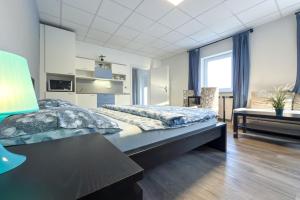 a bedroom with a bed and a table and a chair at Aparthotel DKS in Chomutov