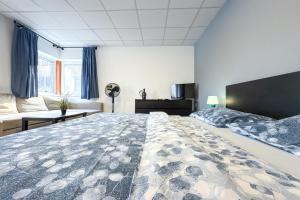 a bedroom with a large bed and a couch at Aparthotel DKS in Chomutov +29 photos