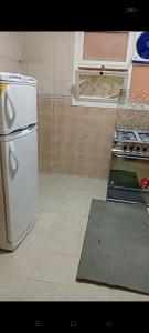 a kitchen with a white refrigerator and a stove at 3BR furnished apartment in Madinaty B1 شقة مفروشة 3 غرف نوم في مدينتي in Madinaty