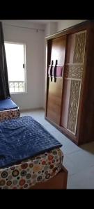 a bedroom with a bed and a refrigerator in it at 3BR furnished apartment in Madinaty B1 شقة مفروشة 3 غرف نوم في مدينتي in Madinaty