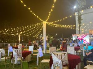 a group of tables and chairs under a tent with lights at GOOSENECK HOTEL and RESTAURANTS in Kandogal
