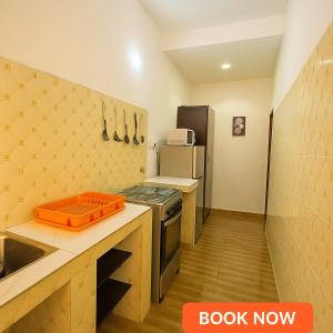 a small kitchen with a stove and a refrigerator at Essential Comfort Haven Homez in Ago Palace in Lagos