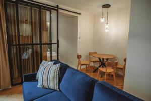 a living room with a blue couch and a table at Modern Luxury Apartment & Parking in Leszno +11 photos