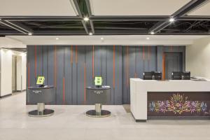 a lobby with a counter and chairs in a room at Go Hotels Plus Bacolod - Newly Renovated in Bacolod
