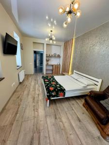 a bedroom with a bed and a television in it at VIP apartment у центрі міста, новобудЖК Театральний,дуже простора in Rivne