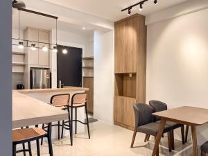 a kitchen and dining room with tables and chairs at Ipoh The Cove Hillside Stay 7 to 10 pax, 5 min to Ipoh Town in Ipoh