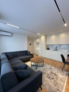 a living room with a couch and a table at Pristina Luxury Apartments 46 in Pristina