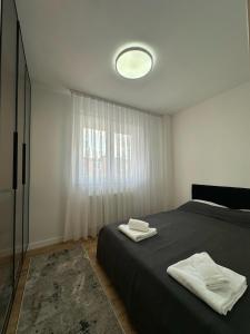 a bedroom with a bed with two towels on it at Pristina Luxury Apartments 46 in Pristina