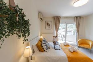 Postel nebo postele na pokoji v ubytování Garnet Studio Flats