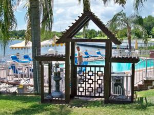 a gazebo by the pool at a resort at Lake Roy Beach Inn - Winter Haven in Winter Haven