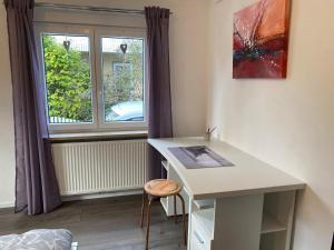 a room with a desk and a window at Ferienwohnung Bianca in Ettenheim +8 photos