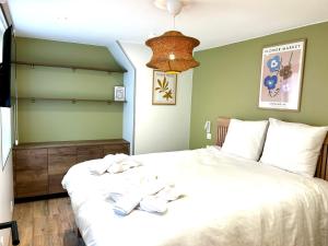 a bedroom with a large bed with towels on it at LILLEHOSTS 2, Vieux Lille, Newly renovated, Modern & Stylish apartment, perfectly located in Lille
