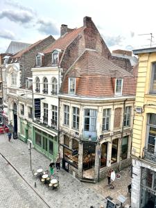 a group of buildings on a city street with tables at LILLEHOSTS 2, Vieux Lille, Newly renovated, Modern & Stylish apartment, perfectly located in Lille