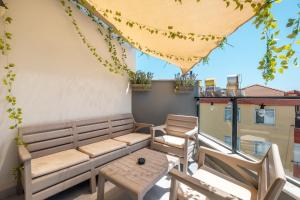 a patio with a couch and chairs on a balcony at Jasmin 9 2+1 in Alanya