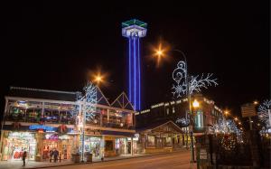 a city with a tower with blue lights on it at Love Me True Holiday home in Gatlinburg