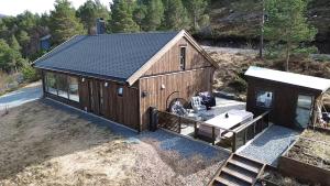 an overhead view of a large wooden building with a sink at Cabin at the end of Skardsøya towards the sea - boat in Bukta +13 photos