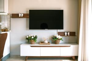 a living room with a tv on a white cabinet at Jasmin 9 2+1 in Alanya
