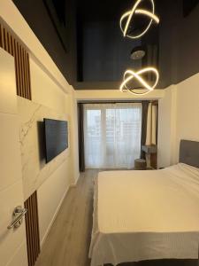a bedroom with a bed and a flat screen tv at MPR Seaview in Năvodari