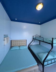a bedroom with two bunk beds and a blue ceiling at La Evangs Beach Resort Taal in San Luis +76 photos