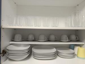 a bunch of plates and cups on a shelf at Apartamento Moni in Benia de Onís +23 photos