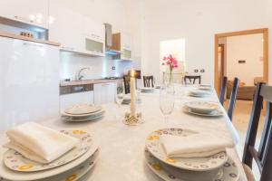 a kitchen with a table with plates and napkins at Villa Petra, a romantic and spectacular villa near the sea in Kukci