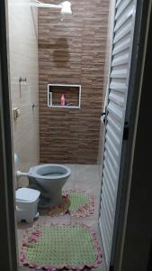 a bathroom with a toilet and a stairs with a rug at Recharge your batteries Arca da Aliança Chalet in Limeira +14 photos
