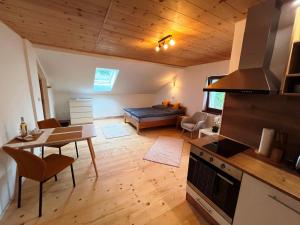 a kitchen and living room with a couch and a table at Apartmán Kunratice 2 in Kunratice