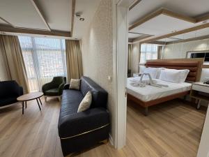a hotel room with a bed and a couch at Alican 1 Hotel in Izmir