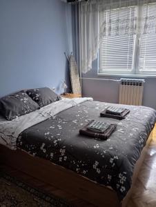 a bedroom with a bed with two towels on it at Apartman Icić in Pirot