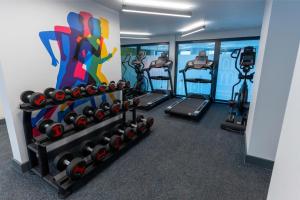 a gym with several treadmills and exercise machines at Riverside House at Guildford in Guildford