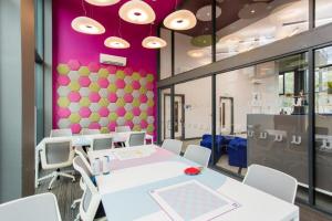 a room with tables and chairs and a purple wall at Riverside House at Guildford in Guildford +23 photos