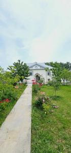 a white house with a sidewalk in a yard at Big yard white villa AYT in Gabala