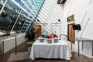 a table with bowls of flowers on it in a building at Naumi Auckland Airport Hotel in Auckland