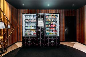 a refrigerator full of drinks in a room at Naumi Auckland Airport Hotel in Auckland