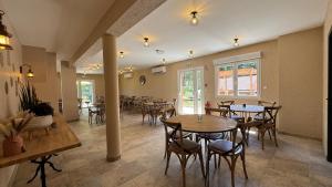 a restaurant with tables and chairs in a room at Gite Clé des Champs in Montenois