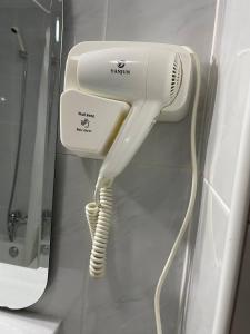 a hair dryer is hanging on a wall at Hotel Capital de Galicia in Santiago de Compostela