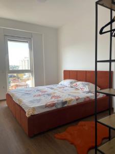 a bedroom with a bed and a window at Skyline Apartment in Pristina
